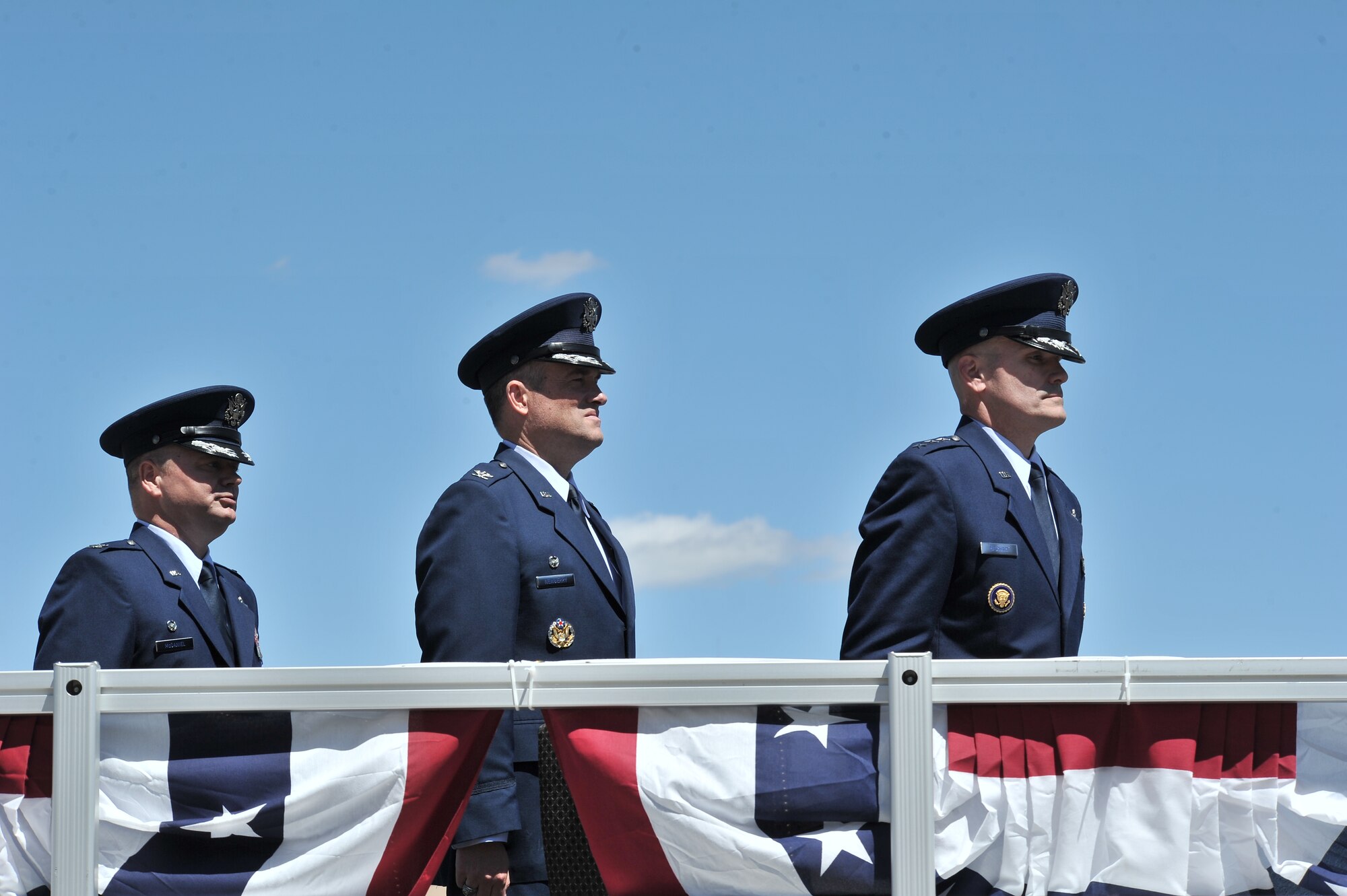 Col. Charles B. McDaniel, Col. Brian M. Newberry and Lt. Gen. Carlton Everhart stand at attention prior to the start of the ceremony during the 92nd Air refueling wing Change of command at Fairchild Air Force Base, Washington, July 25, 2014. The change of command ceremony is a tradition that represents a formal transfer of authority and responsibility. Everhart is the 18th Air Force commander presiding over the change of command from Newberry to McDaniel. (U.S. Air Force photo by Staff Sgt. Alexandre Montes/Released)