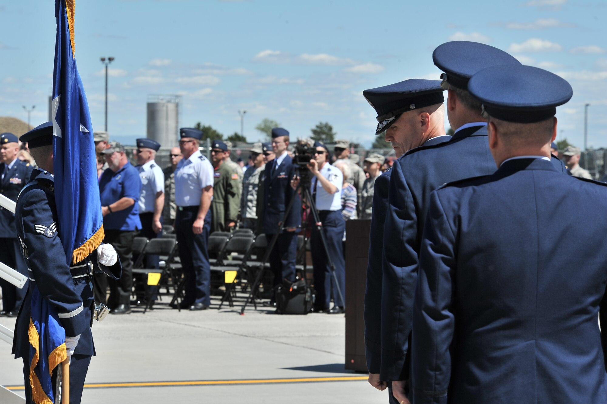Lt. Gen. Carlton Everhart signals to the official party to proceed to the stage during the 92nd Air refueling wing Change of command at Fairchild Air Force Base, Washington, July 25, 2014. The change of command ceremony is a tradition that represents a formal transfer of authority and responsibility. Everhart is the 18th Air Force commander. (U.S. Air Force photo by Staff Sgt. Alexandre Montes/Released)