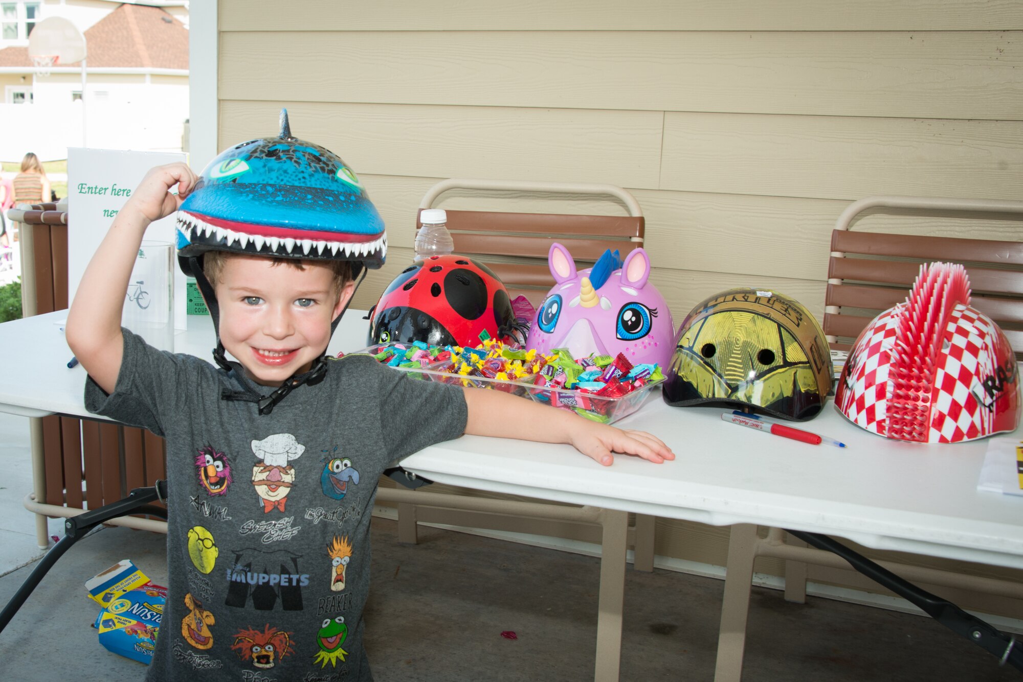 The son of Staff Sgt. Erin Oneil, 81st Security Forces Squadron, poses with his new safety bicycle helmet he won in a raffle during the 81st SFS Bike Rodeo July 25, 2014, at the Forest City Community Center, Keesler Air Force Base, Miss.  The event, hosted by 81st SFS and Forest City Community Services, was held for Keesler families to perform and promote safety checks for bikes and car seats. (U.S. Air Force photo by Marie Floyd)