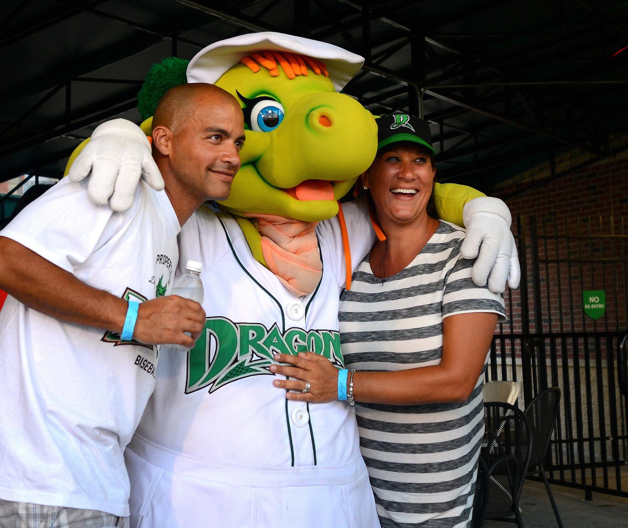 DAYTON, Ohio – Staff Sgt. Harold De La Matta, 445th Aircraft Maintenance Squadron jet engine journeyman, and his wife, Katie, pose with Gem, one of several mascots for the minor league team, during a Dayton Dragons baseball game July 12, 2014. De La Matta and others from the 445th Maintenance Group spent the evening at the game to help enhance unit morale. The Dayton Dragons are a Class A minor league baseball team affiliated with the Cincinnati Reds. (U.S. Air Force photo/Tech. Sgt. Frank Oliver)