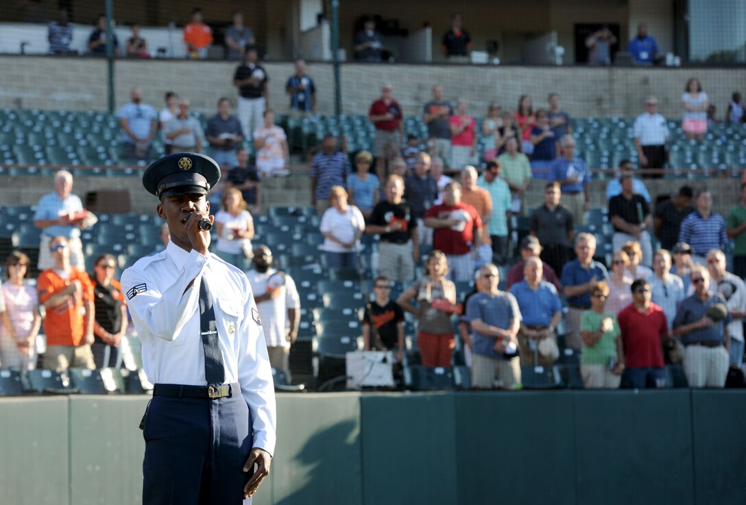 Senior Airman Andre Petway sings the “National Anthem” prior to a minor league game at Prince George’s Stadium in Bowie, Md., July 25, 2014. Petway is an Air Force Honor Guard firing party member. (U.S. Air Force photo/Airman 1st Class Ryan J. Sonnier)