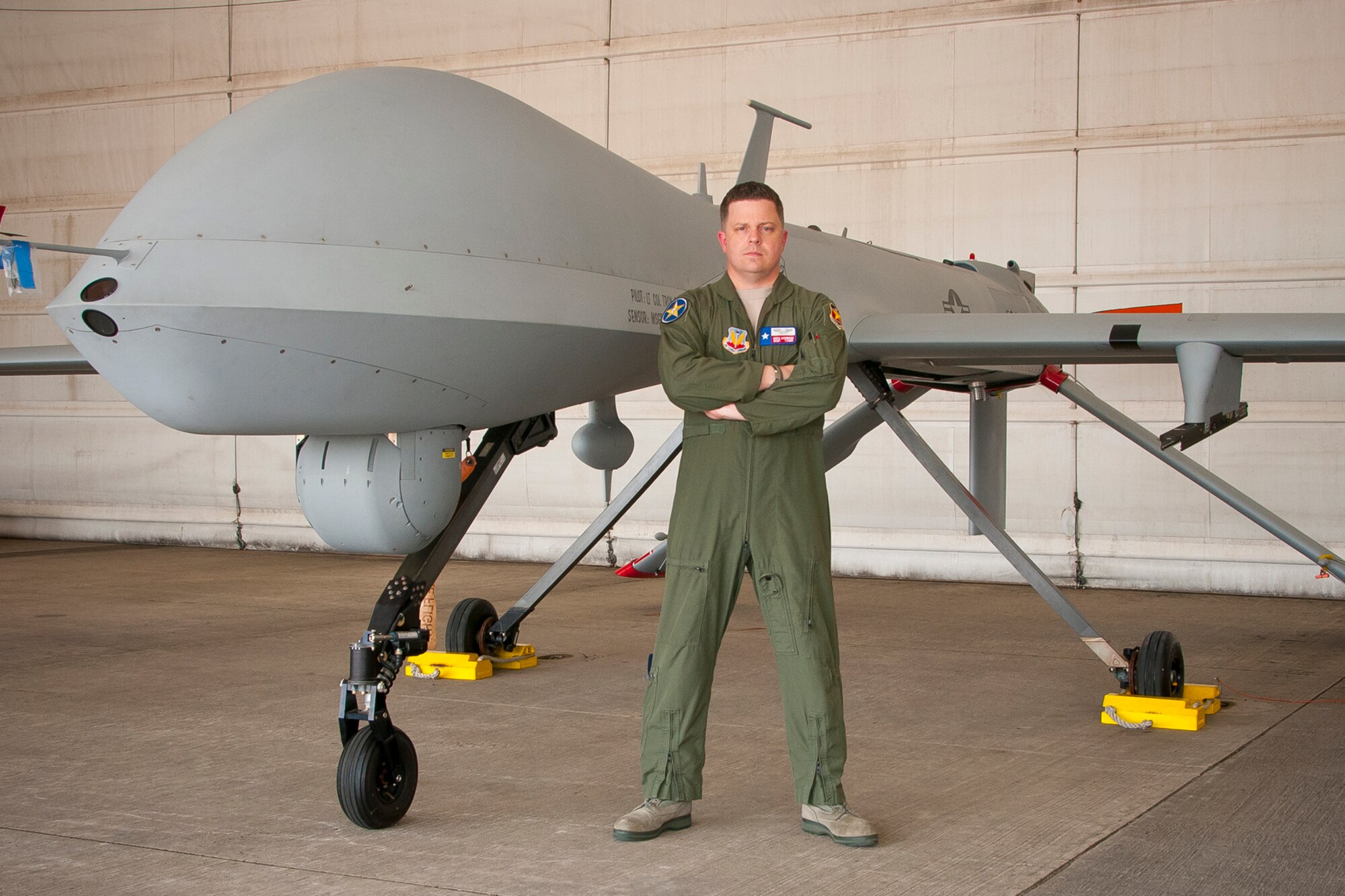 Master Sgt. Joseph G. Ashwood, a remotely piloted aircraft sensor operator assigned to the 111th Reconnaissance Squadron at Ellington Joint Reserve Base, Houston, Texas, stands in front of an MQ-1 Predator. MSgt Ashwood has been named the Air National Guard senior non-commissioned officer of the year. (U.S. Air National Guard photo by Master Sgt. Sean S. Cowher/Released)