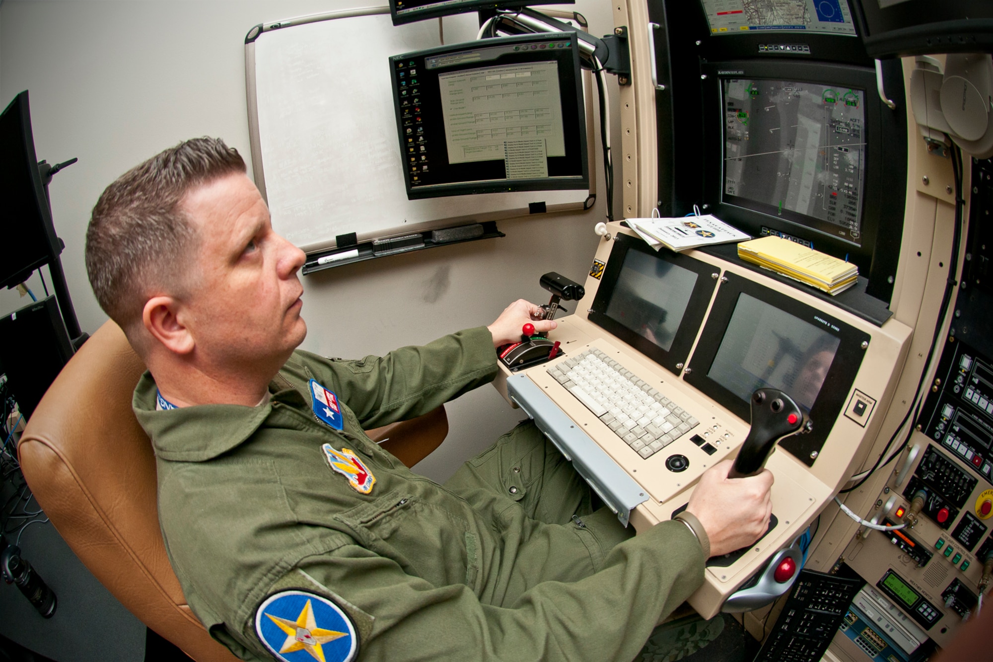 Master Sgt. Joseph G. Ashwood, a remotely piloted aircraft sensor operator assigned to the 111th Reconnaissance Squadron at Ellington Joint Reserve Base, Houston, Texas, flies a training mission on an MQ-1 Predator Ground Control Station simulator. MSgt Ashwood has been named the Air National Guard senior non-commissioned officer of the year. (U.S. Air National Guard photo by Master Sgt. Sean S. Cowher/Released)