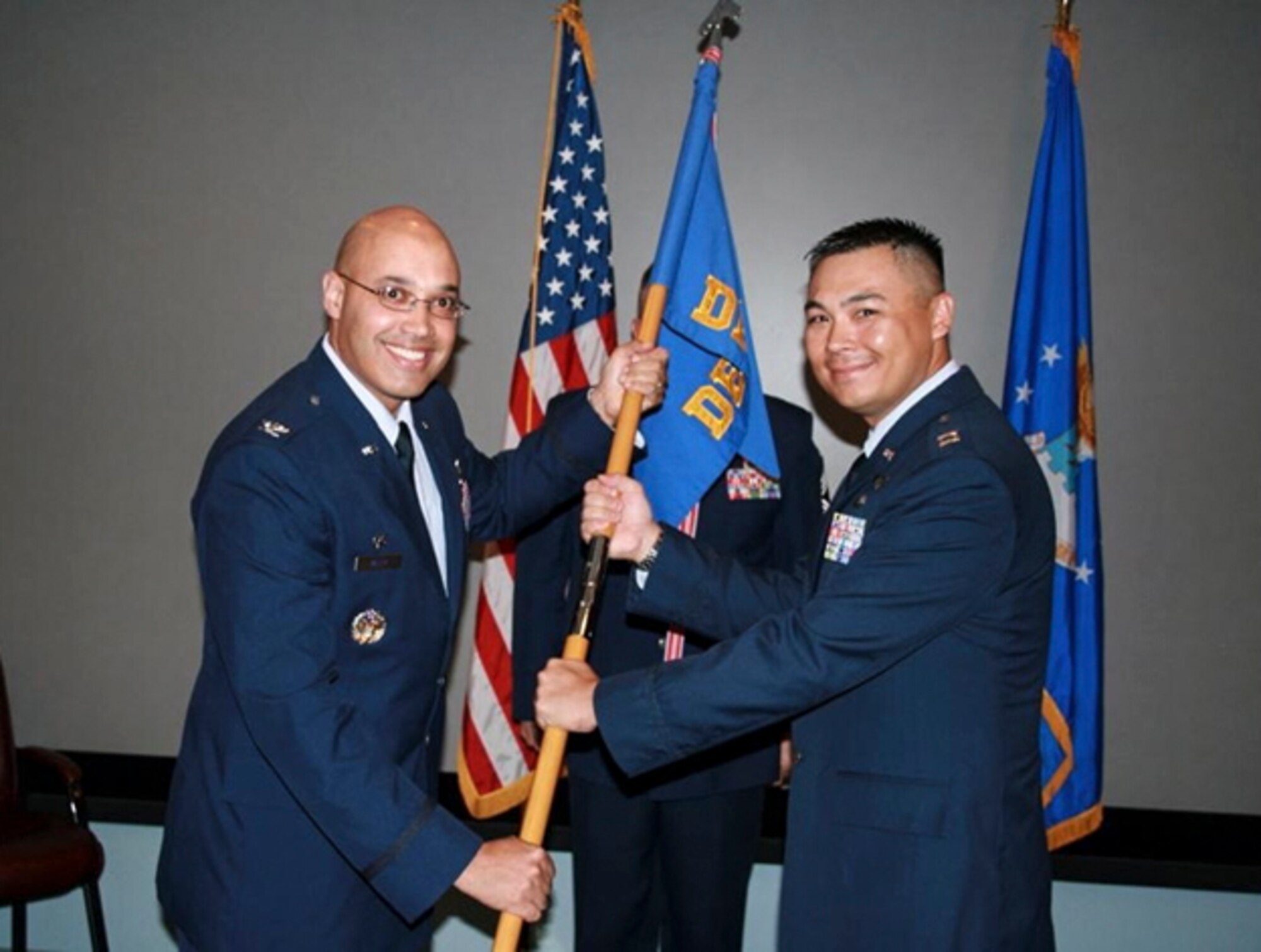 MAUI, Hawaii – Col. David Miller Jr., 21st Operations Group commander, passes the 21st Operations Group, Detachment 3 guidon to Capt. Robert Copely during the Det. 3 change of command ceremony here June 16. Copely assumed command from Capt. Shahn Rashid. Det. 3 is one of three worldwide Ground-based Electro-Optical Deep Space Surveillance Systems units around the globe that track and identify deep space objects using a series of powerful telescopes, providing space situational awareness to the United States and allies. The detachment operates at the Maui Space Surveillance Complex, located atop the 10,023 foot summit of Haleakala, a dormant volcano. (U.S. Air Force photo)