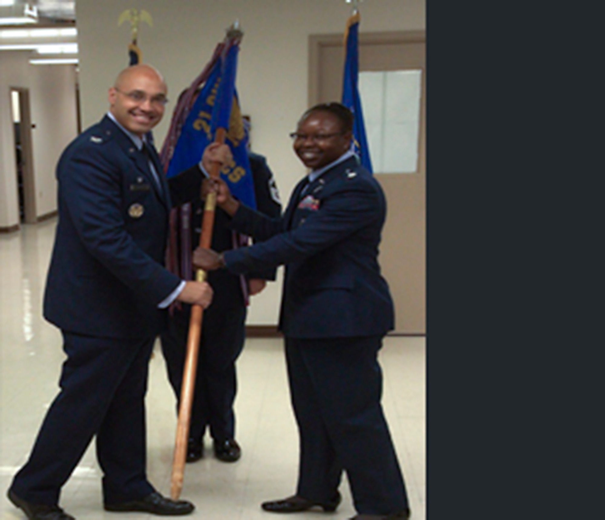 EGLIN AIR FORCE BASE, Fla. – Col. David Miller Jr., 21st Operations Group commander, passes the 20th Space Control Squadron guidon to Lt. Col. Mafwa Kuvibidila during the 20th SPCS change of command ceremony here June 25. Kuvibidila assumed command from Lt. Col. Mitchell Katosic. The 20th SPCS is responsible for detecting, tracking, identifying and reporting on-orbit spacecraft and debris in support of United States Strategic Command and the Joint Space Operations Center. (U.S. Air Force photo)