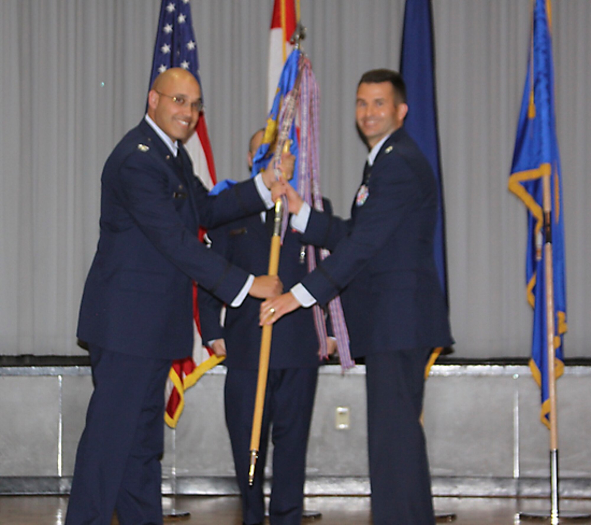 CLEAR AIR FORCE STATION, Alaska – Col. David Miller Jr. (left), 21st Operations Group commander, passes the 13th Space Warning Squadron guidon to Lt. Col. Scott Anderson, during the 13th SWS change of command ceremony here June 13. Anderson assumed command from Lt. Col. Jennifer Jeffries. The 13th SWS provides missile warning of Intercontinental Ballistic Missile and Sea Launched Ballistic Missile attacks against North America. 13th SWS also provides space surveillance of orbiting objects in space to the Joint Space Operations Center at Vandenberg Air Force Base, Calif.  (U.S. Air Force photo)