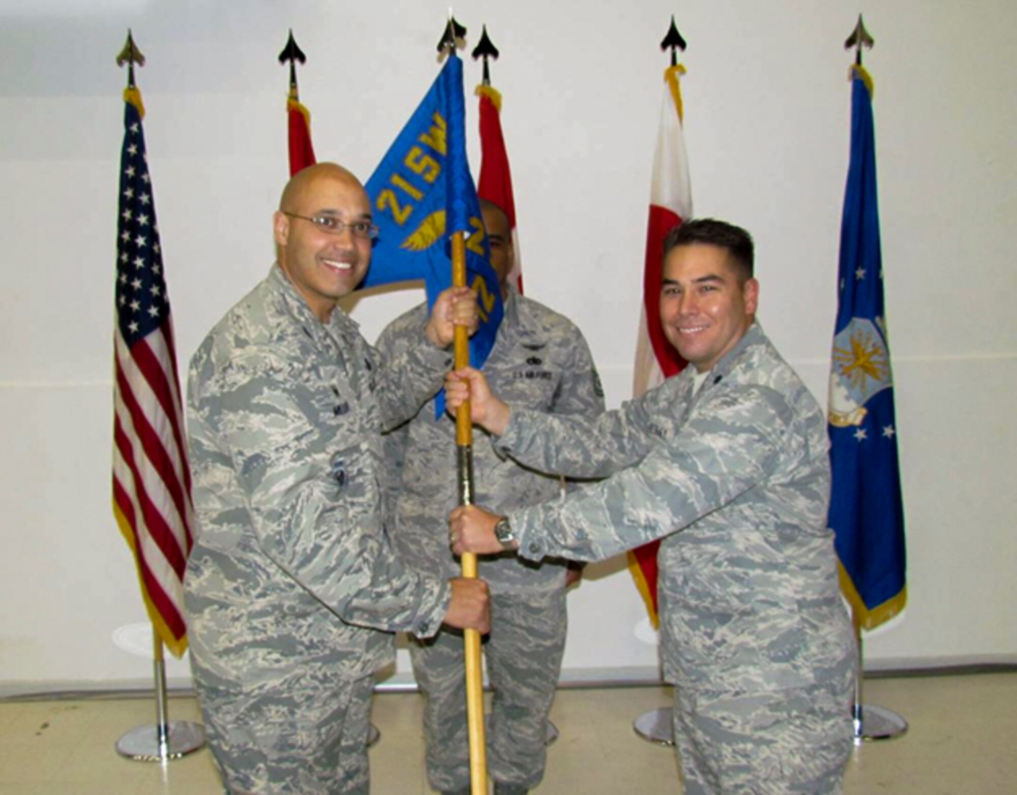 THULE AIR BASE, Greenland – Col. David Miller Jr., 21st Operations Group commander, passes the 12th Space Warning Squadron guidon to Lt. Col. Jason Resley during the 12th SWS change of command ceremony here June 19. Resley assumed command from Lt. Col. Kelly Easler. The 12th SWS is a unit of the 21st Space Wing that provides missile warning of Intercontinental Ballistic Missile and Sea Launched Ballistic Missile attacks against the continental United States and Canada. The unit also tracks on-orbit spacecraft and provides mid-course interception data in support of United States Strategic Command, the Joint Space Operations Center, and the Missile Defense Agency. (U.S. Air Force photo)