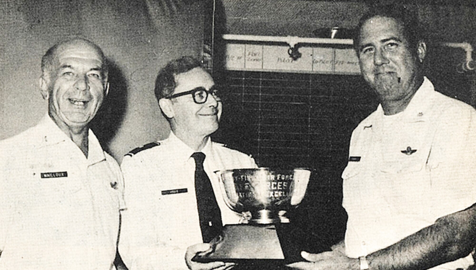 Lt. Col. Larry L. Bandy, 700th Tactical Airlift Squadron commander, (right) accepts the “Debrier Tophy” recognizing the 700th TAS as the top Reserve Forces unit in 21st Air Force. Brig. Gen. Stephen T. Keefe, Jr., 21st Air Force mobilization augmentee, (center) made the presentation. Col. Norman R. Mailloux, 94th Tactical Airlift Wing commander, was also present. (Originally published in the August 1976 Minuteman)