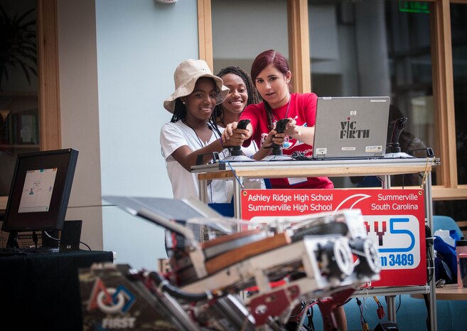 Students learn about FIRST Robotics Competition and operate a robot at Girls Day Out Summer Camp, July 26, 2014, at the College of Charleston. Girls Day Out Summer Camp inspires, attracts and empowers rising 8th and 9th grade girls to pursue Science, Technology, Engineering and Mathematics majors and careers. (U.S. Navy photo/Joe Bullinger)
