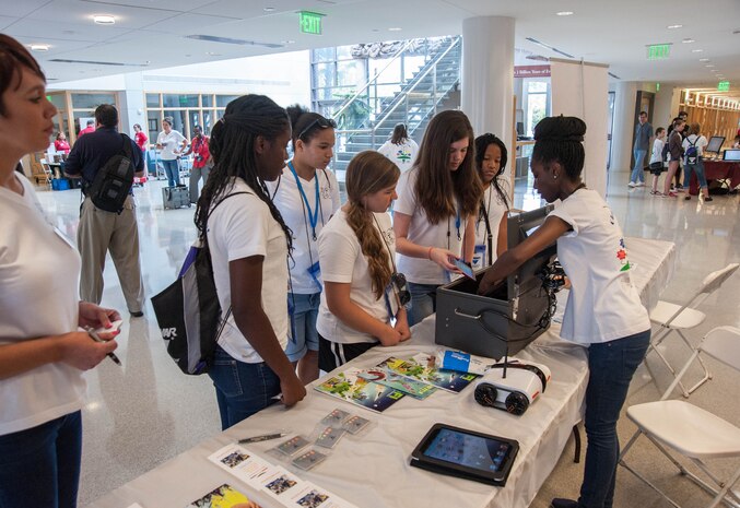 Stephanie Kelly, Space and Naval Warfare Systems Center Atlantic computer scientist, demonstrates how to limit cell phone signals using a Faraday cage as part of mobile device forensics July 26, 2014, during a Girls Day Out Summer Camp at the College of Charleston. Girls Day Out Summer Camp inspires, attracts and empowers rising 8th and 9th grade girls to pursue Science, Technology, Engineering and Mathematics majors and careers. (U.S. Navy photo/Joe Bullinger)
