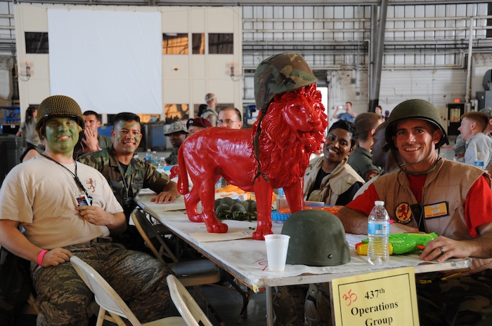 JOINT BASE CHARLESTON, S.C. – Members of the 16th Airlift Squadron display their unit mascot, the lion, during the 2014 Triple Pack Combat Dining Out ceremony July 26, 2014, at Joint Base Charleston, S.C.  The Dining Out custom is rooted in military history and tradition, and affords service members the chance to bond over food, drink and activities. (U.S. Air Force photo/1st Lt. Christopher Love)