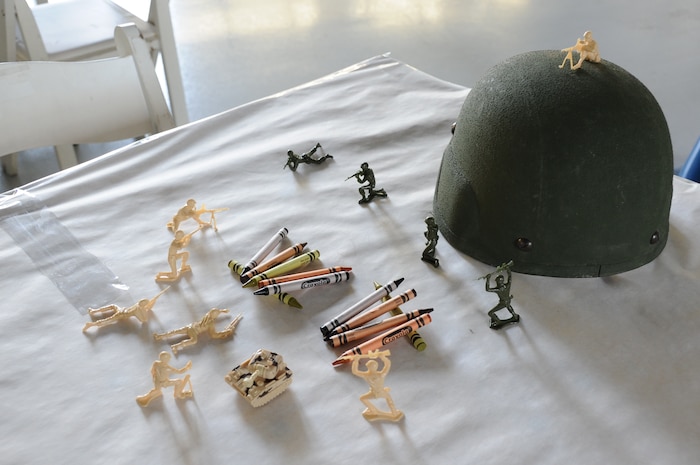 JOINT BASE CHARLESTON, S.C. – Army men battle on a table at the 2014 Triple Pack Combat Dining Out ceremony July 26, 2014, at Joint Base Charleston, S.C. The Dining Out custom is rooted in military history and affords service members the chance to bond over food, drink and activities. Other table-toppers included water balloons and further items meant to add ambience to the “Combat” Dining Out. (U.S. Air Force photo/1st Lt. Christopher Love)