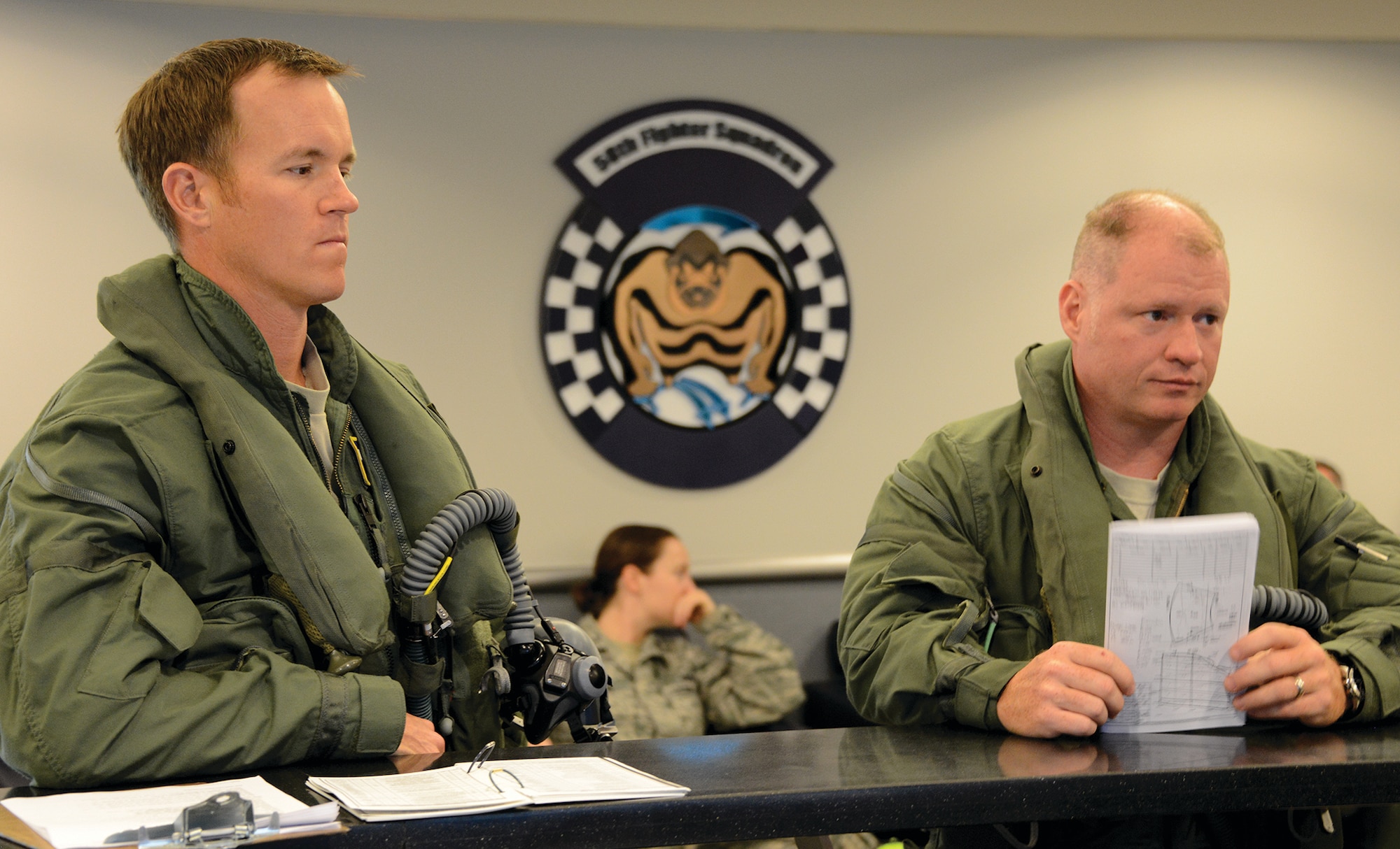 Air Force Reserve pilots Lt. Col. Andy Faulkner (left) and Lt. Col. Brett Robison take part in a pre-flight briefing before heading to their aircraft. (Master Sgt. Chance Babin)
