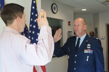 Col. David C. Post, 910th Airlift Wing Maintenance Group commander, administers the oath of enlistment to his son, David M. Post, at the recruiting building here, July 25, 2014. Post’s son was recently selected as an Air Force officer candidate by a local board and Air Force Reserve Command Headquarters board. The 22-year-old Post recently graduated with a Bachelor of Science degree in Entrepreneurship from Grove City College, Pennsylvania. He will attend Officer Training School before heading to a navigator school to become a C-130H Hercules navigator at Youngstown Air Reserve Station. U.S. Air Force photo/Eric M. White