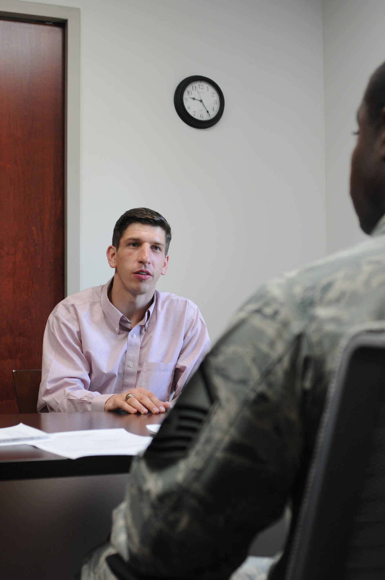 Master Sgt. Dartanion Pittrell, a 910th Airlift Wing line recruiter, discusses enlistment details with David M. Post, a new recruit Friday, July 25, here. Post is the son of Col. David C. Post, 910th Airlift Wing Maintenance Group commander. Post was selected by a local board and an Air Force Reserve Command Headquarters board as an Air Force officer candidate. The 22-year-old Post recently graduated with a Bachelor of Science degree in Entrepreneurship from Grove City College, Pennsylvania. He will attend Officer Training School before heading to a navigator school to become a C-130H Hercules navigator here. His father had the honor of administering his oath of enlistment. U.S. Air Force photo/Eric M. White.