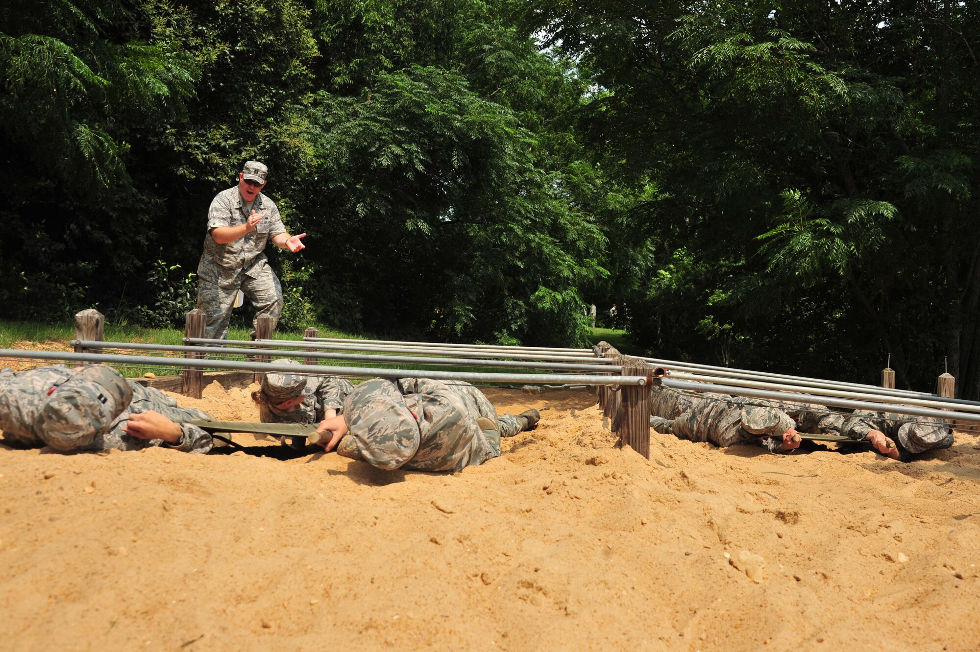 Capt. Brian Walker, 23rd Training Squadron Commissioned Officer Training course instructor, pushes his class through a field training exercise July 24, 2014. Walker is the first judge advocate to teach COT. He is also an Air Force Reserve member, and owns a law practice in Fort Worth Texas. The school often integrates Reserve and Guard members into their staff to strengthen total force initiatives. (U.S. Air Force photo by Staff Sgt. Natasha Stannard)