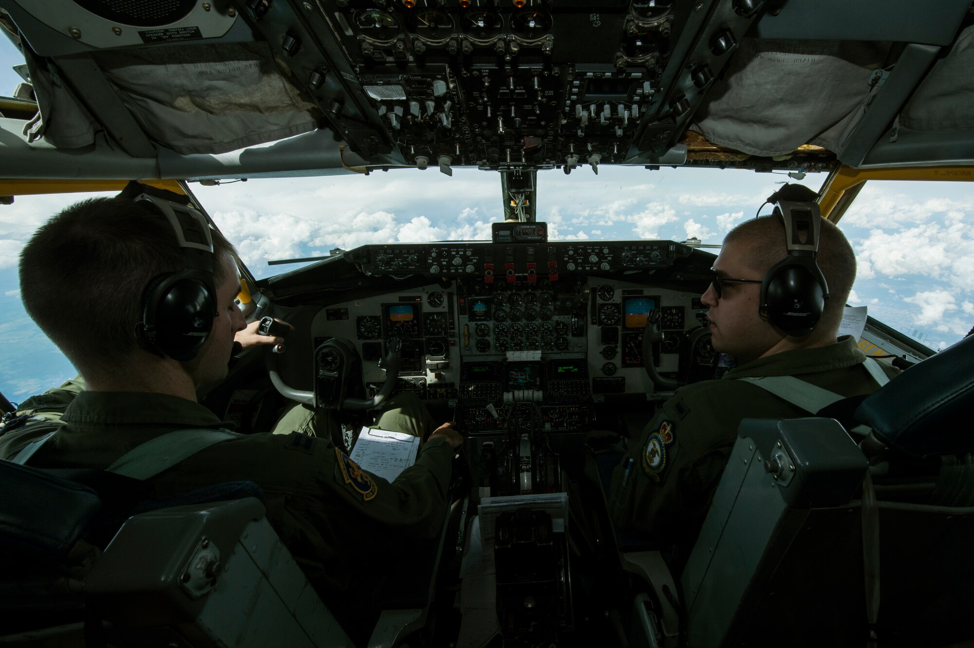 U.S. Air Force Capt. Paul Paskell, a KC-135 Stratotanker aircraft commander, left, and 1st Lt. Jack Ryan, co-pilot, both assigned to the 351st Air Refueling Squadron assigned to Royal Air Force Mildenhall, England, control the aircraft during an aerial refueling operation over   Ramstein, Germany, July 24, 2014.  The mission allowed two different flying wings the 52nd Fighter Wing and the 100th Air Refueling Wing an opportunity to train together. (U.S. Air Force photo by Senior Airman Rusty Frank/Released)