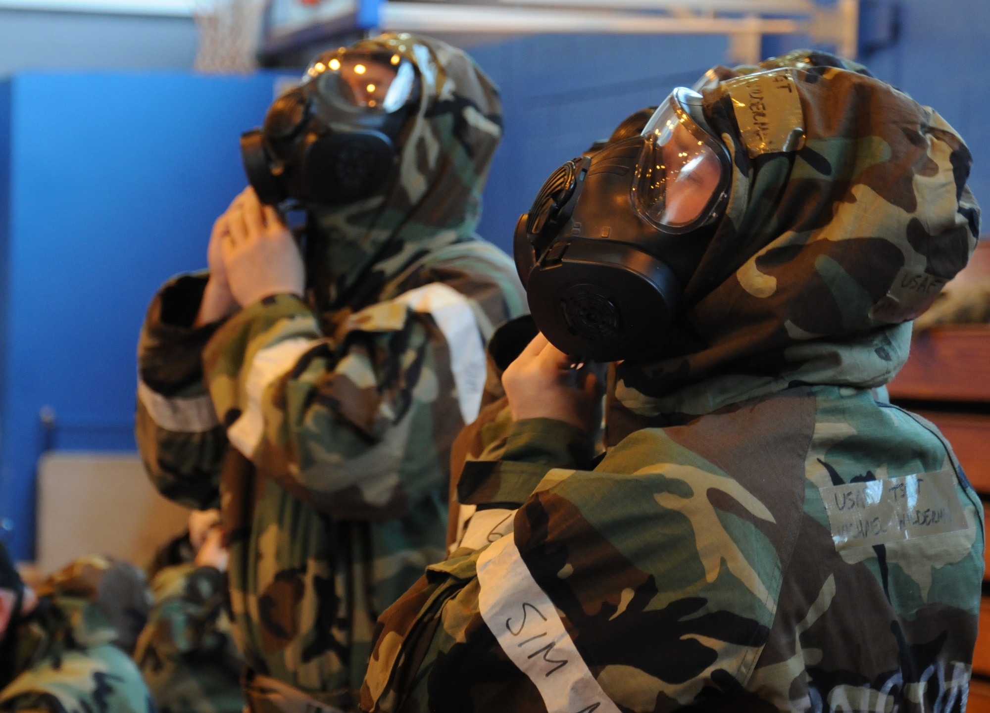 Airmen dress in full personal protective equipment during training July 25, 2014, on RAF Mildenhall, England. Team Mildenhall members learned to safely operate a weapon during ability to survive and operate and chemical, biological, radiological and nuclear training. (U.S. Air Force photo/Gina Randall/Released)