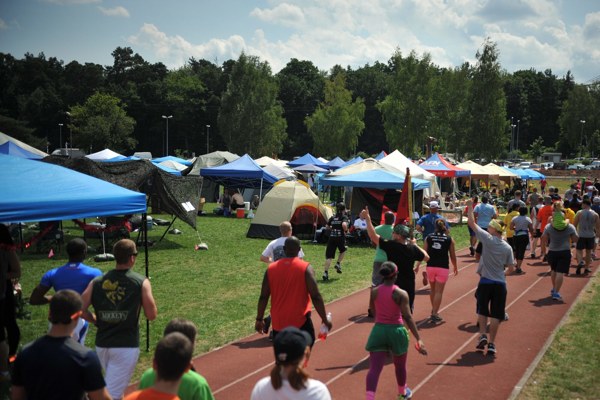 Participants of the 2014 Viking Challenge walk and run around the track to raise money for the Fisher House, July 25, 2014 at the Pulaski Park track. The fundraising event brought in more than 1,500 participants. (U.S. Air Force photo/Senior Airman Hailey Haux)