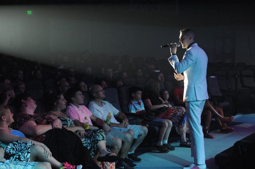 U.S. Air Force Airman 1st Class Kyle McCarty, Tops in Blue vocalist, walks up to the crowd as he performs one of his solos at the Keystone Theater on Kadena Air Base, Okinawa, Japan, July 27, 2014. Tops in Blue is an all-active duty Air Force special unit made up of talented amateur performers selected for their entertainment abilities. (U.S. Air Force photo by Airman 1st Class Zackary A. Henry/Released)