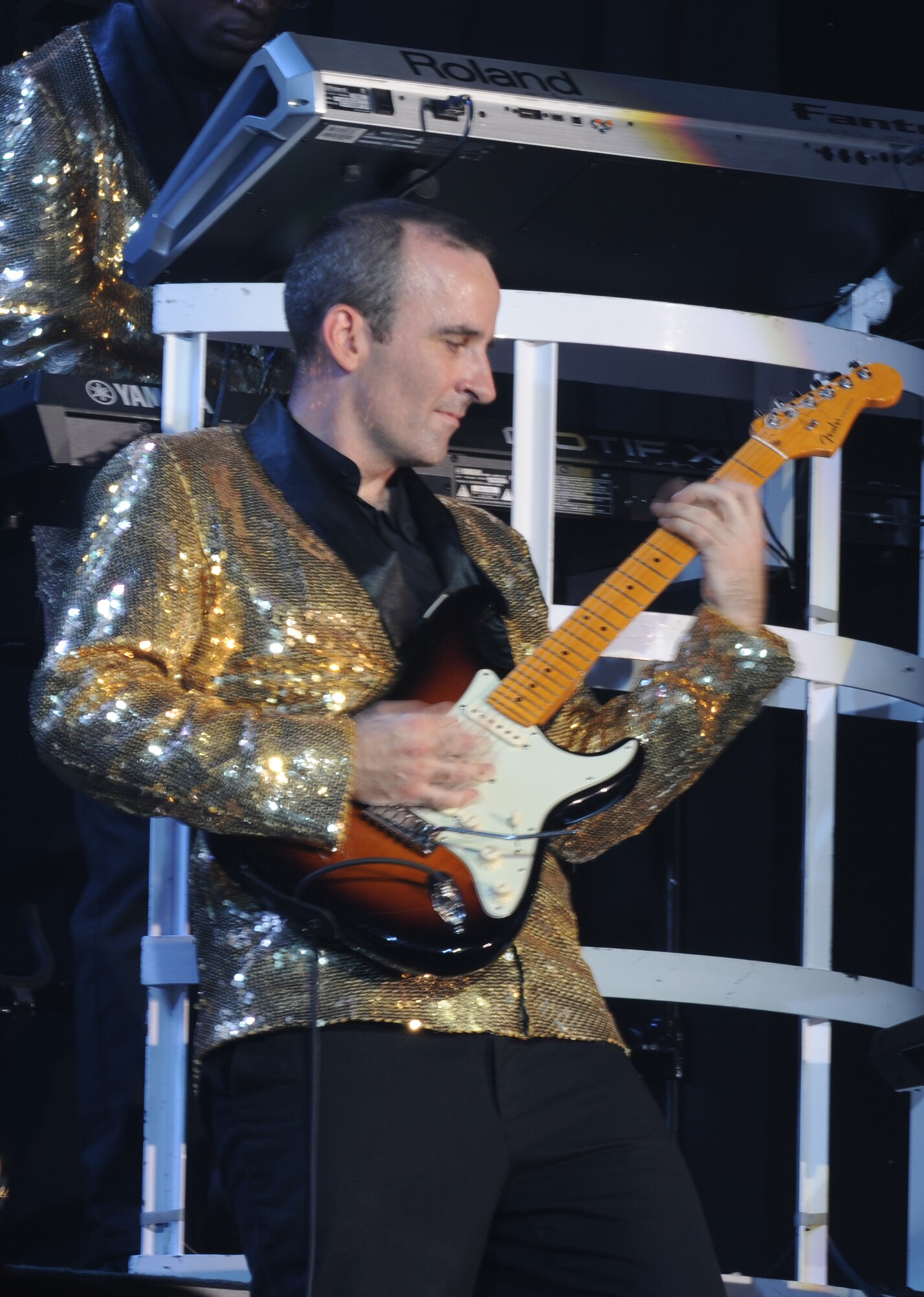 U.S. Air Force Master Sgt. Justin Worle, Tops in Blue band member, rocks a perfect solo with blazing speed at the Keystone Theater on Kadena Air Base, Okinawa, Japan, July 28, 2014. Tops in Blue is a special all-active duty Air Force unit made up of talented amateur performers selected for their entertainment abilities.  (U.S. Air Force photo by Airman 1st Class Zackary A. Henry/Released)