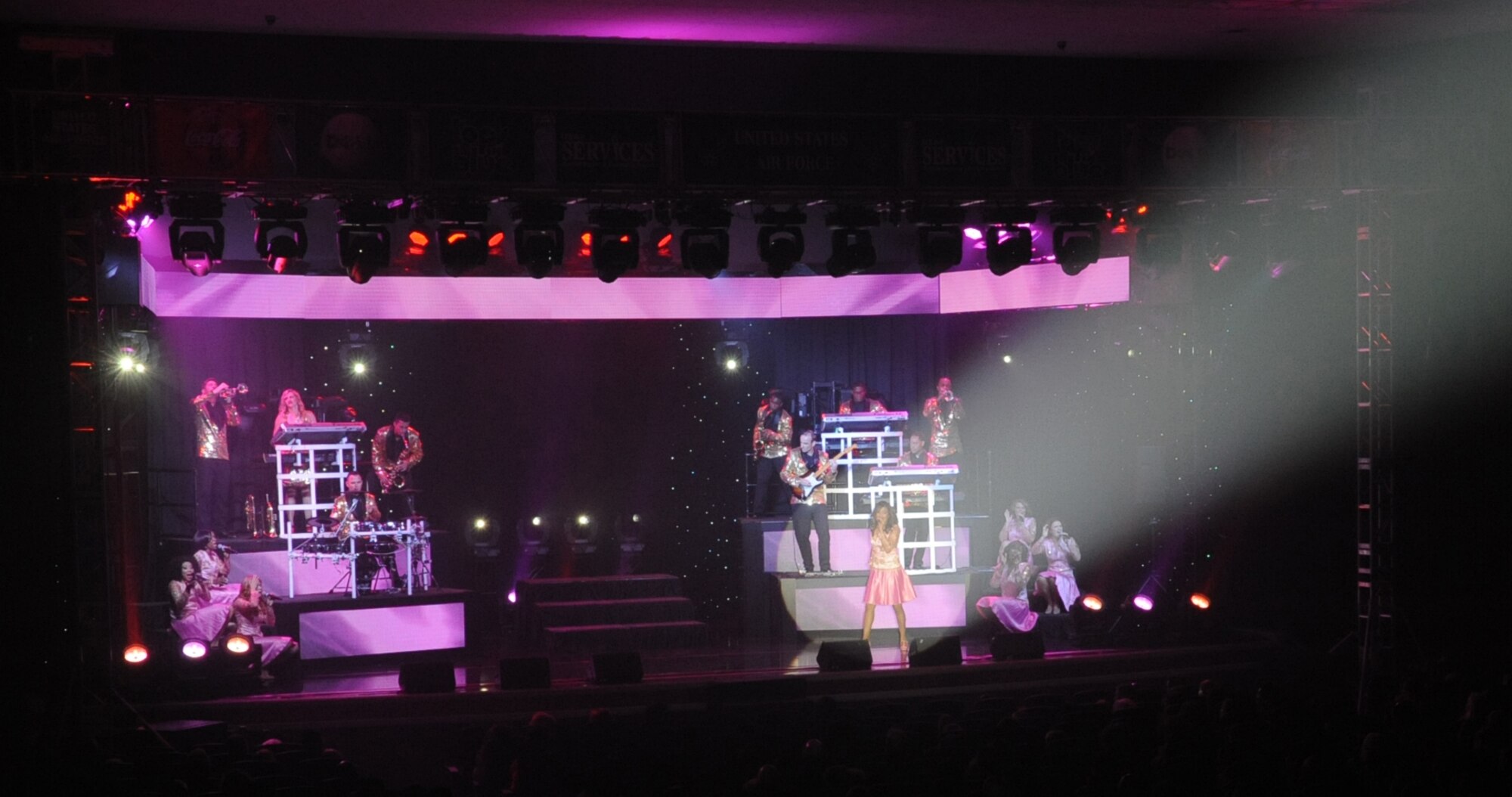 The spotlight picks out one of Tops in Blue's vocalists as she astounds the audience at the Keystone Theater on Kadena Air Base, Okinawa, Japan, July 28, 2014. Tops in Blue's primary purpose is to perform for military personnel and their families throughout the world. (U.S. Air Force photo by Airman 1st Class Zackary A. Henry/Released)