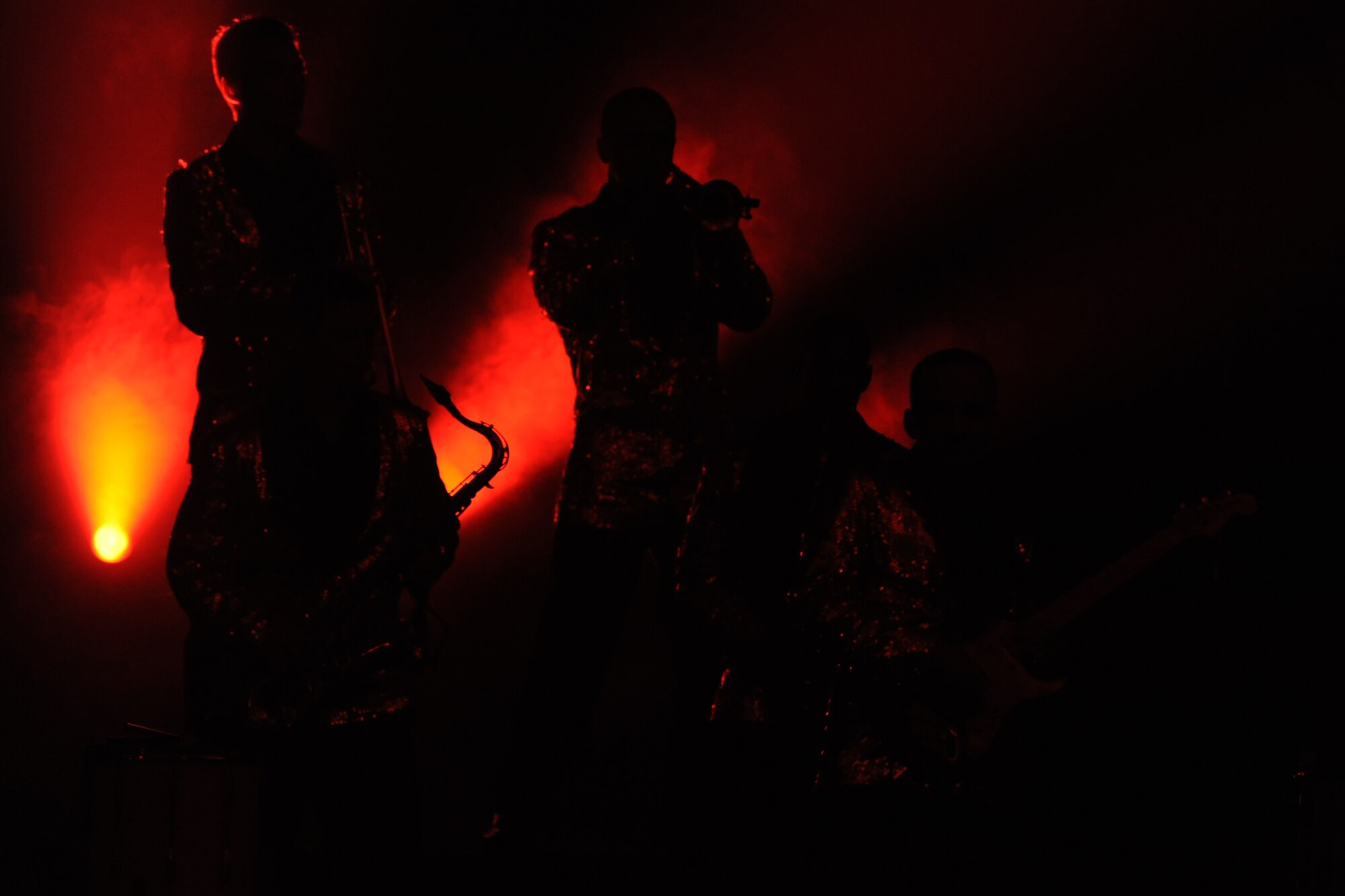 Tops in Blue members take the stage and prepare for their next song at the Keystone Theater on Kadena Air Base, Okinawa, Japan, July 28, 2014. Tops in Blue is an Air Force global entertainment unit dedicated to providing entertainment to the Air Force family. (U.S. Air Force photo by Airman 1st Class Zackary A. Henry/Released)