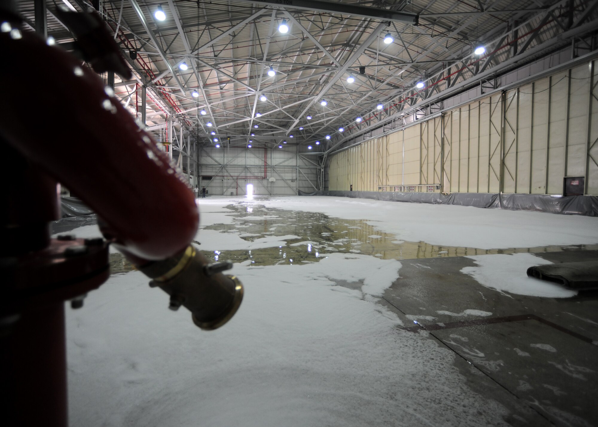A new fire suppressant system in a hangar is function tested July 25, 2014, Incirlik Air Base, Turkey. All the system components use water and foam to extinguish fires and is one of three at Incirlik AB. (U.S. Air Force photo by Staff Sgt. Caleb Pierce/Released)