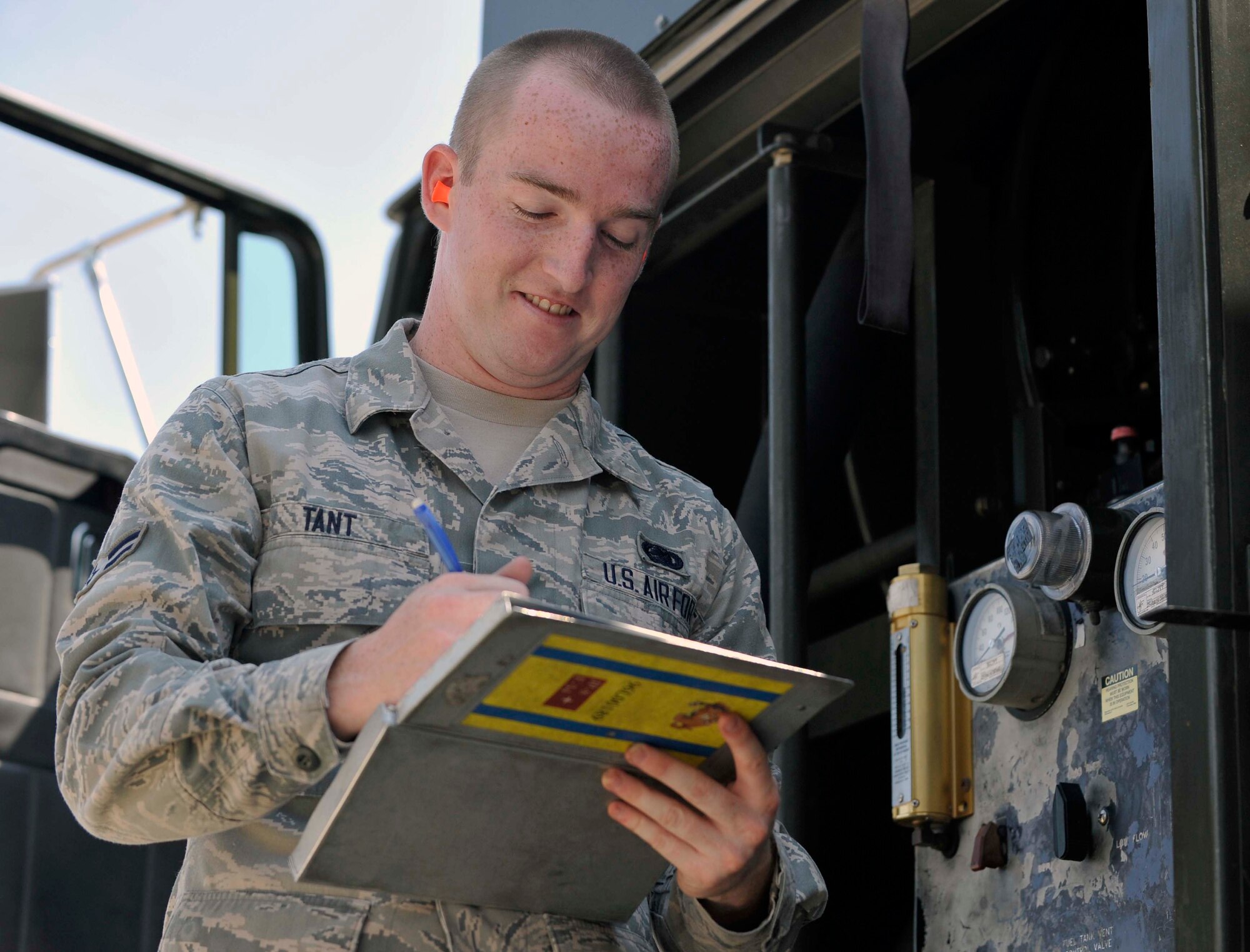 U.S. Air Force Airman 1st Class Shaun Tant, 35th Logistics Readiness Squadron fuels distribution operator, reviews his checklist after beginning the fueling process on an aircraft at Misawa Air Base, Japan, July 25, 2014. After ensuring the aircraft has been safely grounded and fitted with a fuel hose, Tant completes his checklist, monitoring the pounds per square inch gauges, making sure to observe the correct amount of fuel is being deposited into the aircraft before the pump is disconnected. (U.S. Air Force photo/Airman 1st Class Patrick S. Ciccarone