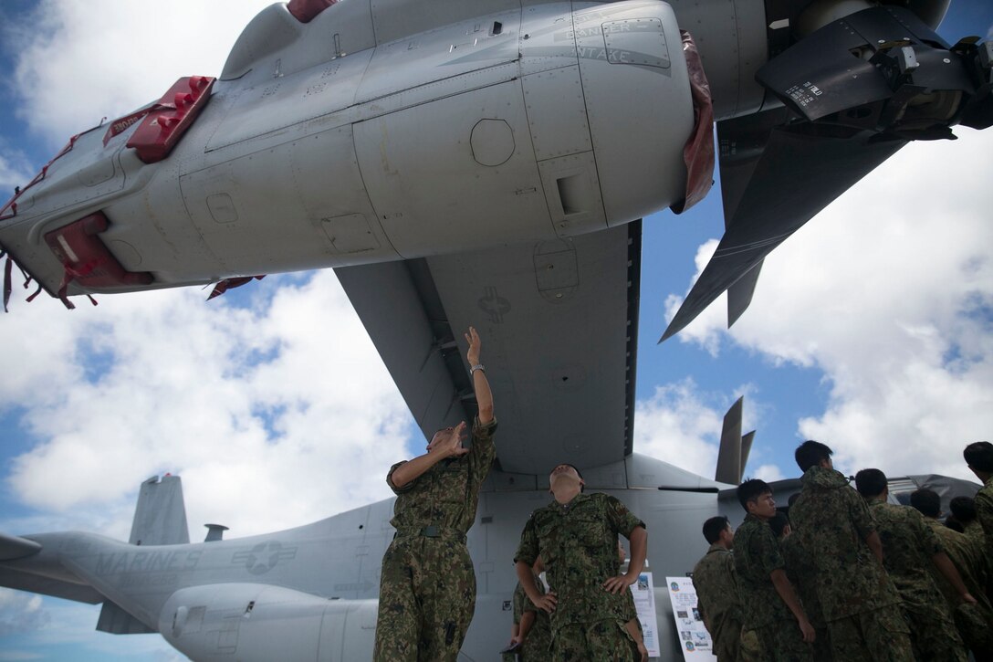 Japan Ground Self-Defense Force officers view and discuss the engines of the MV-22B Osprey tiltrotor aircraft July 18 on Marine Corps Air Station Futenma. The officers attended a demonstration of the Marine Corps’ rotor and tiltrotor aircraft and aircraft maintenance. The JGSDF officers are aircraft maintenance workers and pilots with 15th Aviation Squadron, 15th Brigade, Western Army.