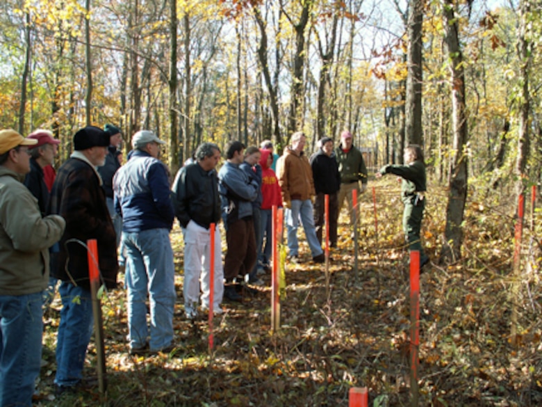 Mary Sue Bowers, natural resources specialist, Coralville Lake, talks to adjacent landowners about oriental bittersweet, an invasive species threatening Iowa’s woodlands.