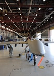 Members of the 174th Fighter Wing maintenance group prepare a MQ-9 Reaper for its initial taxi at Wheeler-Sack Army Air Field at Fort Drum, N.Y., on June 30, 2011. The pre-taxi activity took place in temporary hanger space provided by the Army's 10th Mountain Division. This milestone represented the unit's first step toward flying the MQ-9 from its detachment at Fort Drum. The wing is based at Hancock Field in Syracuse, N.Y.