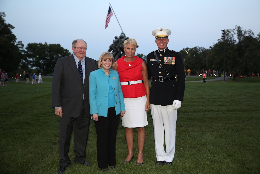 Dr. David R. Patterson, Anne W. Patterson, assistant secretary Bureau of Near Eastern Affairs, Mrs. Kate Brilakis, and Maj. Gen. Mark A. Brilakis, commanding general, Marine Corps Recruiting Command (MCRC) (left to right) pose at the U.S. Marine Corps War Memorial, here, July 29. For this year's MCRC-sponsored Sunset Parade hosted by Gen. Brilakis, Mrs. Patterson attended as the guest of honor to view the performance of the The United States Marine Drum and Bugle Corps and precision drill by the Marine Corps Silent Drill Platoon. (U.S. Marine Corps photo by Lance Cpl. Jessica Quezada/Released)