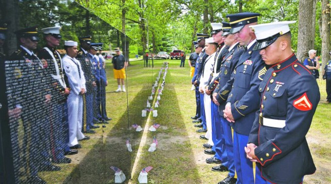 A Fort Leonard Wood joint service color guard looks at the Vietnam Veterans Traveling Memorial Wall Friday at Licking, Mo. A Fort Leonard Wood color guard and honor guard team participated in opening and closing ceremonies for the wall each evening Friday through Sunday. Col. Brian Bisacre, U.S. Army Military Police School assistant commandant, spoke at the event.
