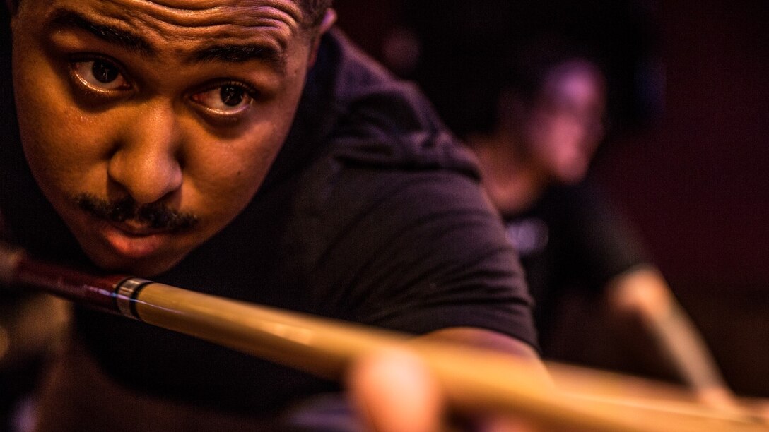 Sergeant Benjamin Eric-King Smith focuses on his shot while playing a round of billiards in Oceanside, Calif., July 22, 2014. Smith, 24, is from Wilmington, Delaware and is currently the transportation coordinator for the 15th Marine Expeditionary Unit aboard Camp Pendleton, Calif.   (U.S. Marine Corps photo by Cpl. Emmanuel Ramos/Released)