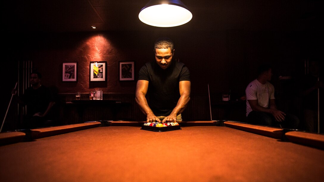 Sergeant Benjamin Eric-King Smith racks the billiard balls before playing a round in Oceanside, Calif., July 22, 2014. Smith, 24, is from Wilmington, Delaware and is currently the transportation coordinator for the 15th Marine Expeditionary Unit aboard Camp Pendleton, Calif.   (U.S. Marine Corps photo by Cpl. Emmanuel Ramos/Released) 