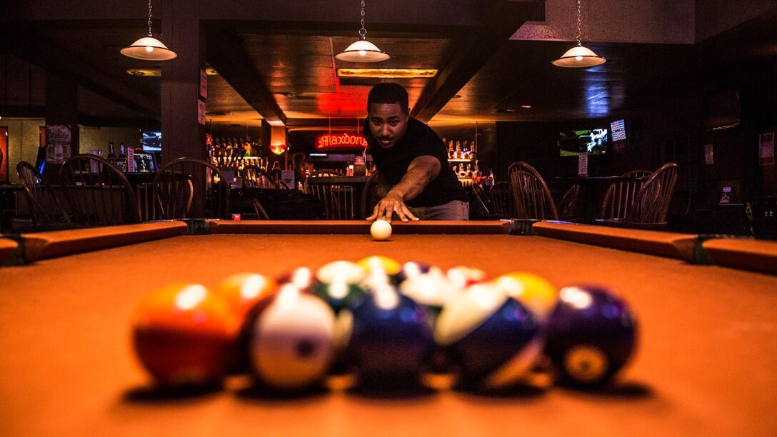 Sergeant Benjamin Eric-King Smith aims the cue ball while playing a round of billiards in Oceanside, Calif., July 22, 2014. Smith, 24, is from Wilmington, Delaware and is currently the transportation coordinator for the 15th Marine Expeditionary Unit aboard Camp Pendleton, Calif.  (U.S. Marine Corps photo by Cpl. Emmanuel Ramos/Released) 