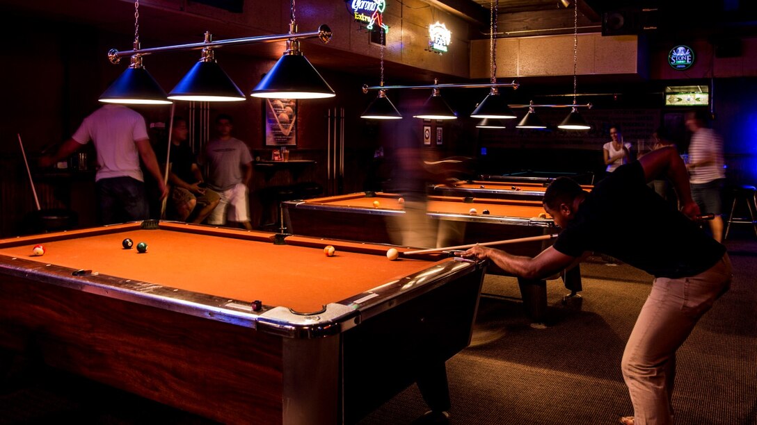 Sergeant Benjamin Eric-King Smith focuses on his shot while playing a round of billiards in Oceanside, Calif., July 22, 2014. Smith, 24, is from Wilmington, Delaware and is currently the transportation coordinator for the 15th Marine Expeditionary Unit aboard Camp Pendleton, Calif.  (U.S. Marine Corps photo by Cpl. Emmanuel Ramos/Released)