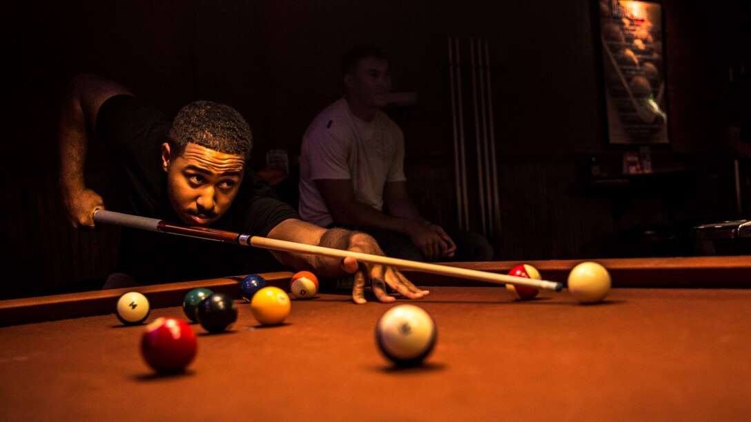 Sergeant Benjamin Eric-King Smith aims the cue ball while playing a round of billiards in Oceanside, Calif., July 22, 2014. Smith, 24, is from Wilmington, Delaware and is currently the transportation coordinator for the 15th Marine Expeditionary Unit aboard Camp Pendleton, Calif.  (U.S. Marine Corps photo by Cpl. Emmanuel Ramos/Released) 