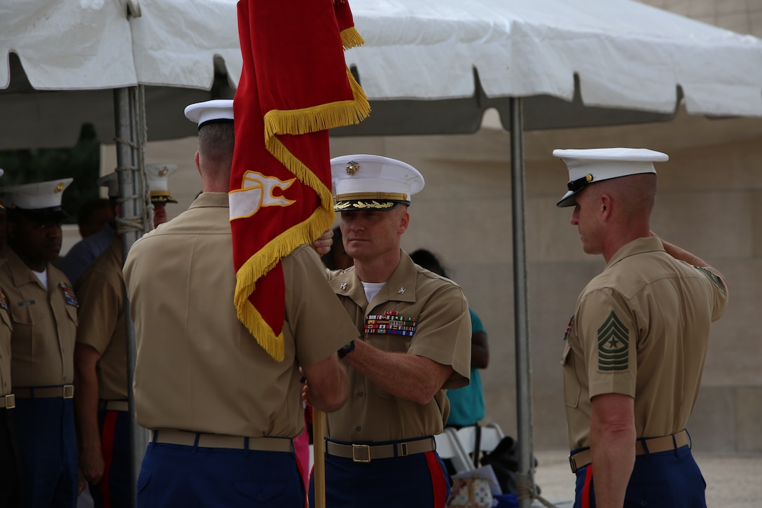 Col. Jason Morris, incoming commanding officer of the 9th Marine Corps District, retrieves the organizational colors from Col. James Minick, outgoing commanding officer, July 18, at Kansas City’s Liberty Memorial. Minick was instrumental in the relocation of 9MCD’s headquarters from Kansas City, Mo., to Great Lakes Naval Training Center, Great Lakes, Ill.