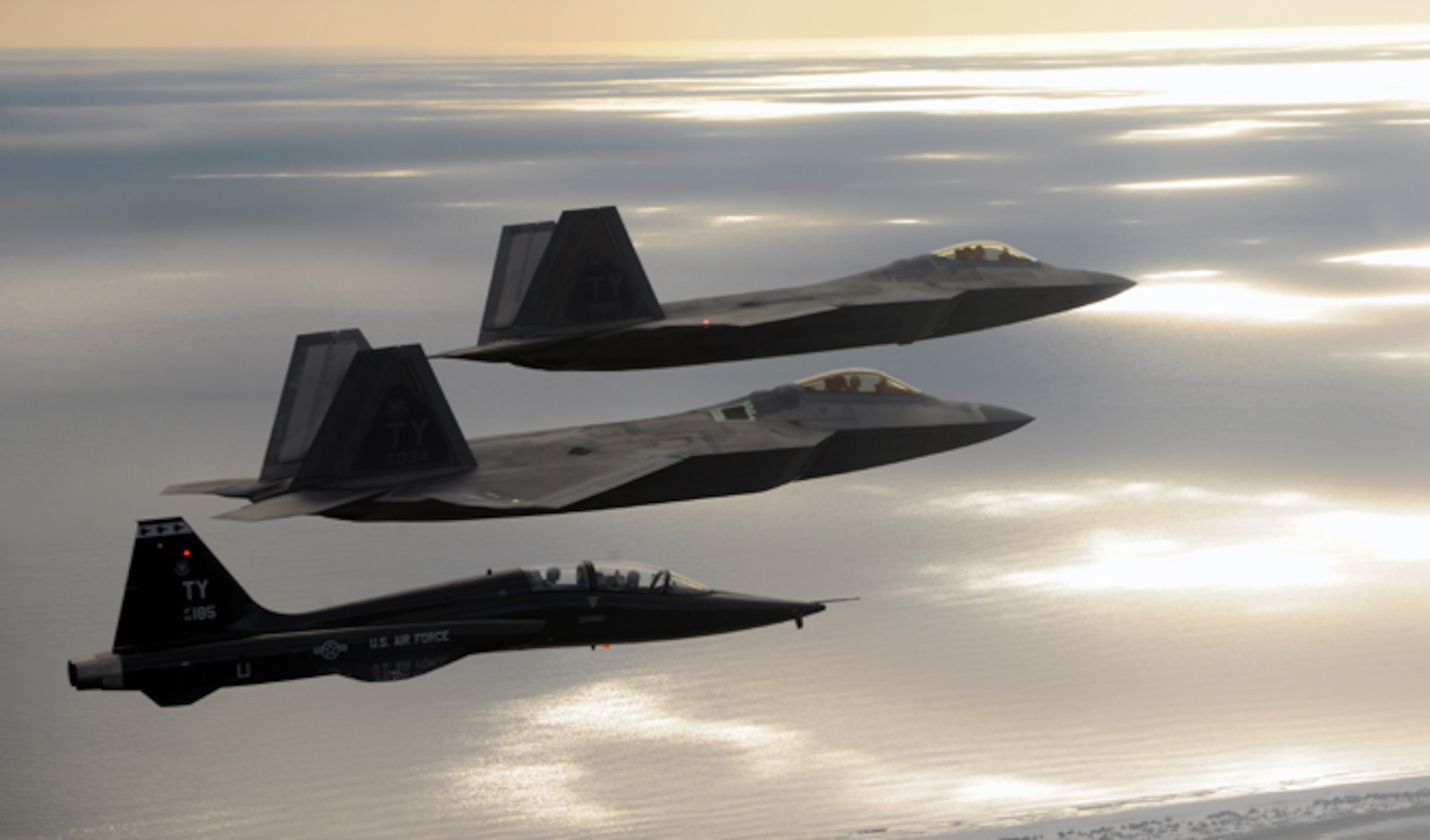 Two F-22 Raptors and a T-38 Talon from Tyndall Air Force Base, Florida, fly together during a 43rd Fighter Squadron Basic Course training mission Oct. 7, 2013 over Florida. A sortie begins when an individual aircraft takes off and ends when it lands. The 43rd FS is the only squadron in the world that trains and develops F-22 pilots. (U.S. Air Force photo/Master Sgt. J. Wilcox)
