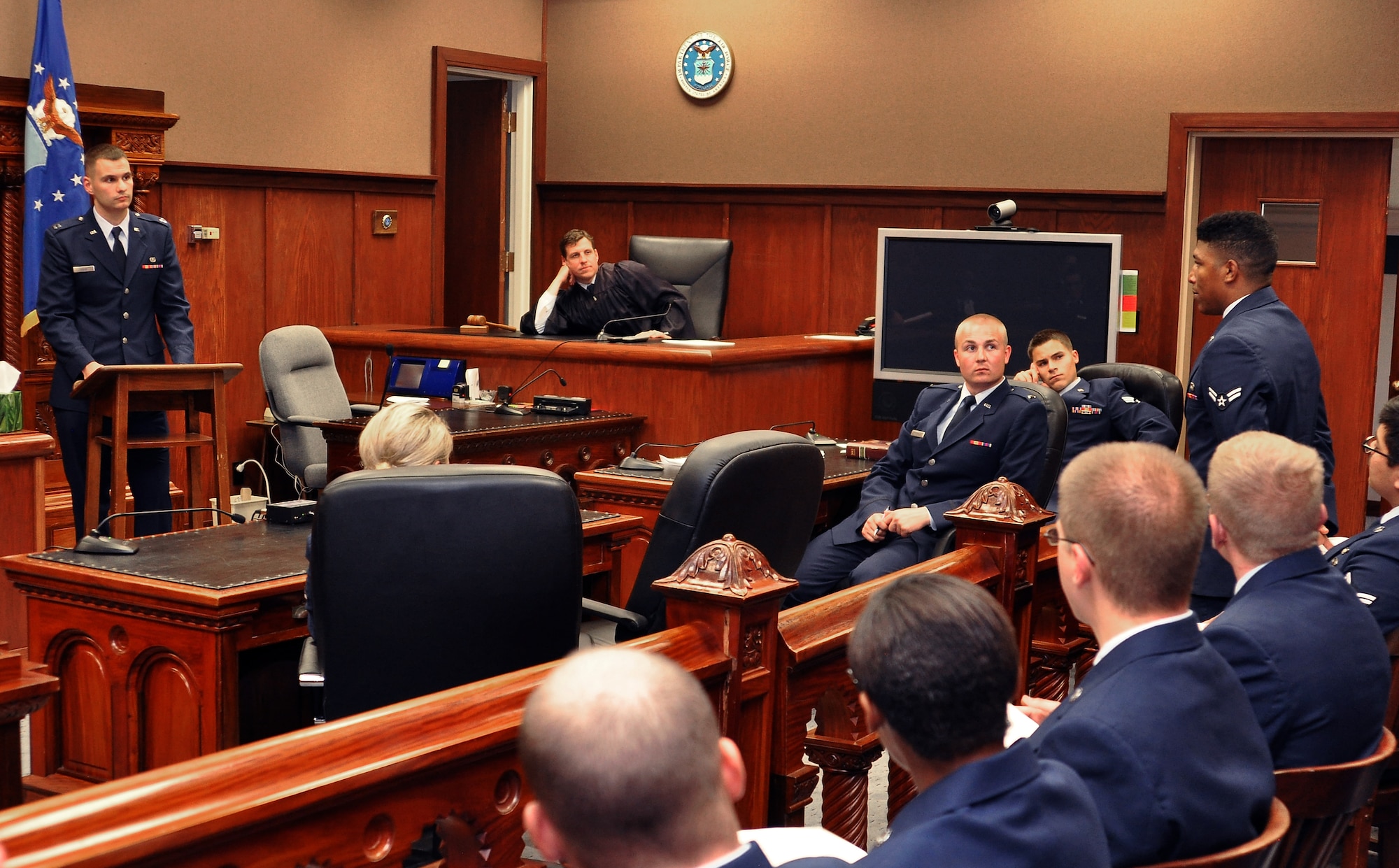 Airman 1st Class Mychal Allen (right) asks Capt. Dave Rolek questions during the first ever ‘mock trial’ held June 9, 2014, inside the Offutt Air Force Base Courtroom, Neb. All Airmen attending the week-long First Term Airmen’s Center orientation course will participate in a mock trial as part of their training. The 55th Wing Legal Office created the program with the goal of preventing sexual assault through education and awareness. Allen is from the 55th Maintenance Squadron and Rolek is a 55th Wing assistant staff judge advocate.  (U. S. Air Force photo/Delanie Stafford)