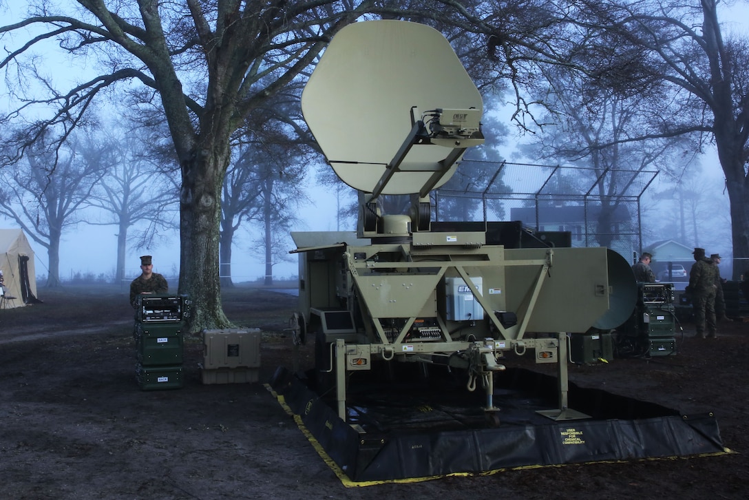 Marines from 8th Communication Battalion stand by their display at the II Marine Headquarters Group Enabler Battalion Capability Expo on January 15. 8th Communications Bn featured a Very Small Aperture Terminal (VSAT-L), a two way satellite used to send transmissions to other ground satellites.