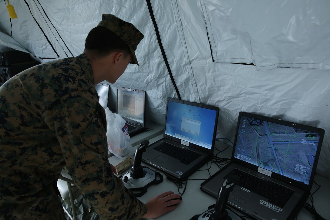 Marine from 2nd Air Naval Gunfire Liaison Company finishes setting up the flight simulation computer program for his display at the II Marine Headquarters Group Enabler Battalion Capability Expo on January 15. 2nd ANGLICO featured several flight simulations to show their units capabilities.