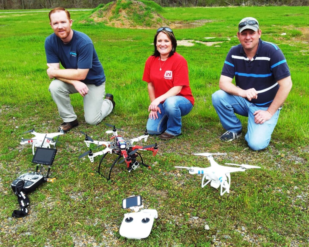 EL’s team from the Environmental Risk Assessment Branch for unmanned aircraft systems  (EPR-UAS) showing their remotely controlled  flying machines are, from left, Justin Wilkens with the Phantom 2 Vision; Jenny Laird with the Flamewheel F550; and Robbie Boyd with the second Phantom 2. Project managers can contact team members to schedule a demonstration of the UASs and learn about monitoring or sampling of dangerous or environmentally sensitive sites. EL photo.