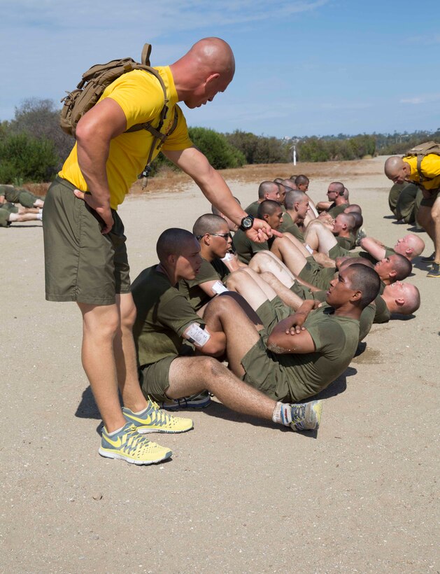 Recruits of Fox Company conduct timed crunches during a physical fitness session at Marine Corps Recruit Depot San Diego, July 28. The purpose of this physical fitness session was to show each recruit what areas of fitness he needs to improve on before the initial physical fitness test that takes place on training day 22.