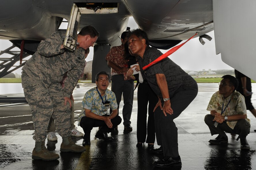 U.S. Air Force Brig. Gen. James Hecker, 18th Wing commander, shows Kurayoshi Takara, vice governor of Okinawa, and his team the inner workings of an F-15 during a tour on Kadena Air Base, Japan, July 30, 2014. During the tour, Takara visited sacred and historical sites on base and learned about the 18th Wing’s history and mission. (U.S. Air Force photo by Airman 1st Class Zade C. Vadnais/Released)