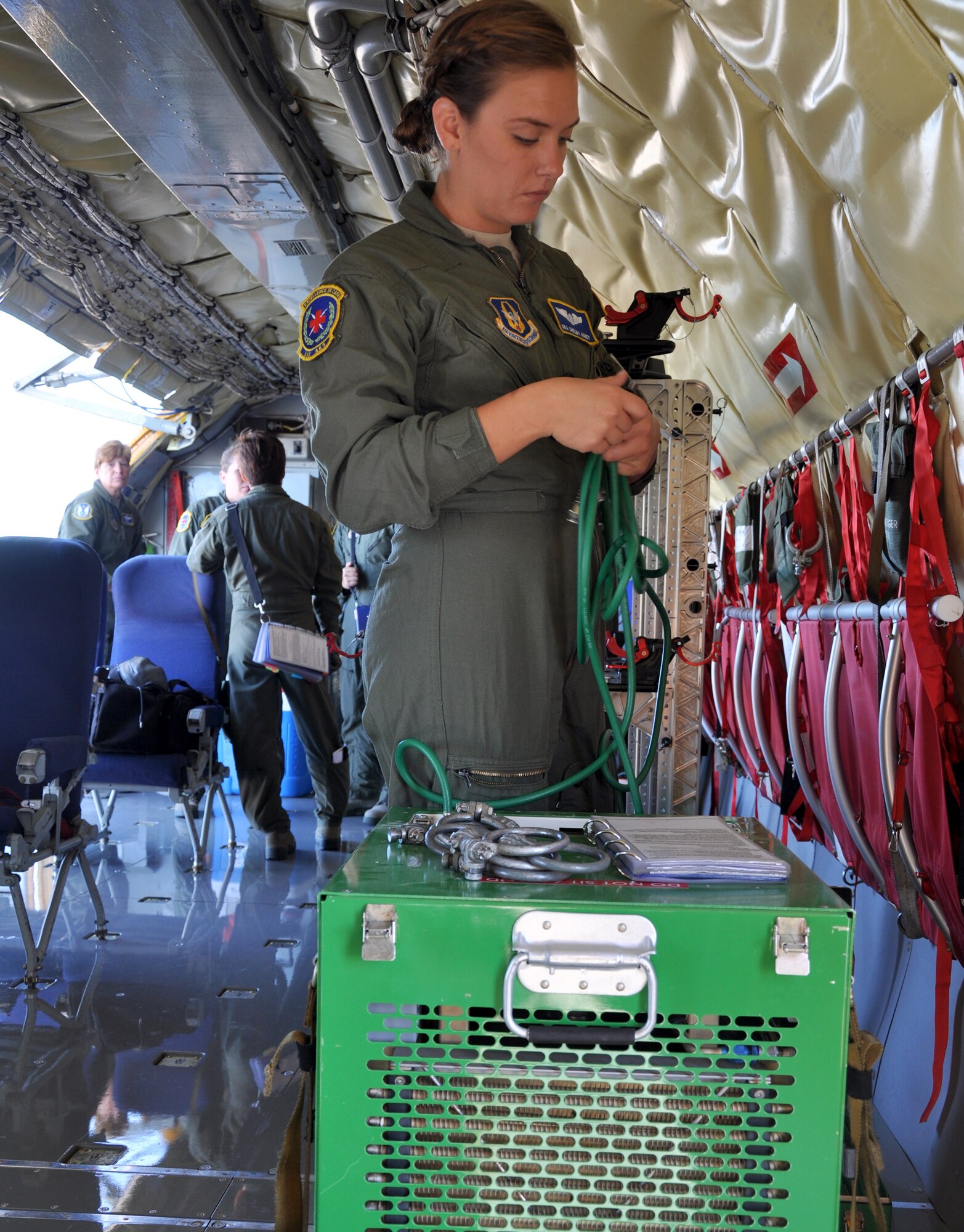 Senior Airman Shelby Adney, 349th Aeromedical Evacuation Squadron technician, preps a McConnell KC-135 Stratotanker before a team exercise at Travis AFB, Calif., July 25, 2014.  Epitomizing the total concept, a flight crew consisting of seven McConnell Airman trained 12 members of the 349th AES Airmen July 25-28.  (U.S. Air Force photo by Staff Sgt. Abigail Klein)