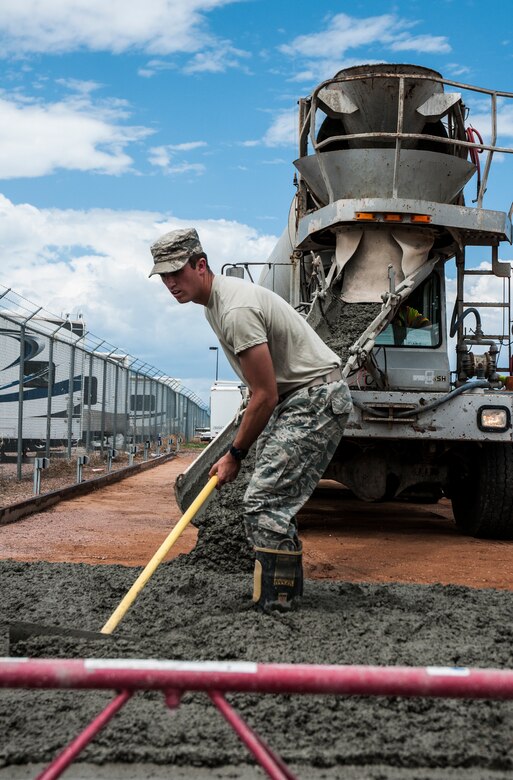 Airman 1st Class Scott Norfleet, 50th Civil Engineer Squadron, distributes cement July 25, 2014, at Schriever Air Force Base, Colo. Norfleet worked with 911th Civil Engineer Squadron, a unit from Pittsburgh Air Reserve Station, Pennsylvania, to complete a portion of the pad for the Outdoor Recreation recreational vehicle parking lot. (U.S. Air Force photo/Staff Sgt. Julius Delos Reyes)