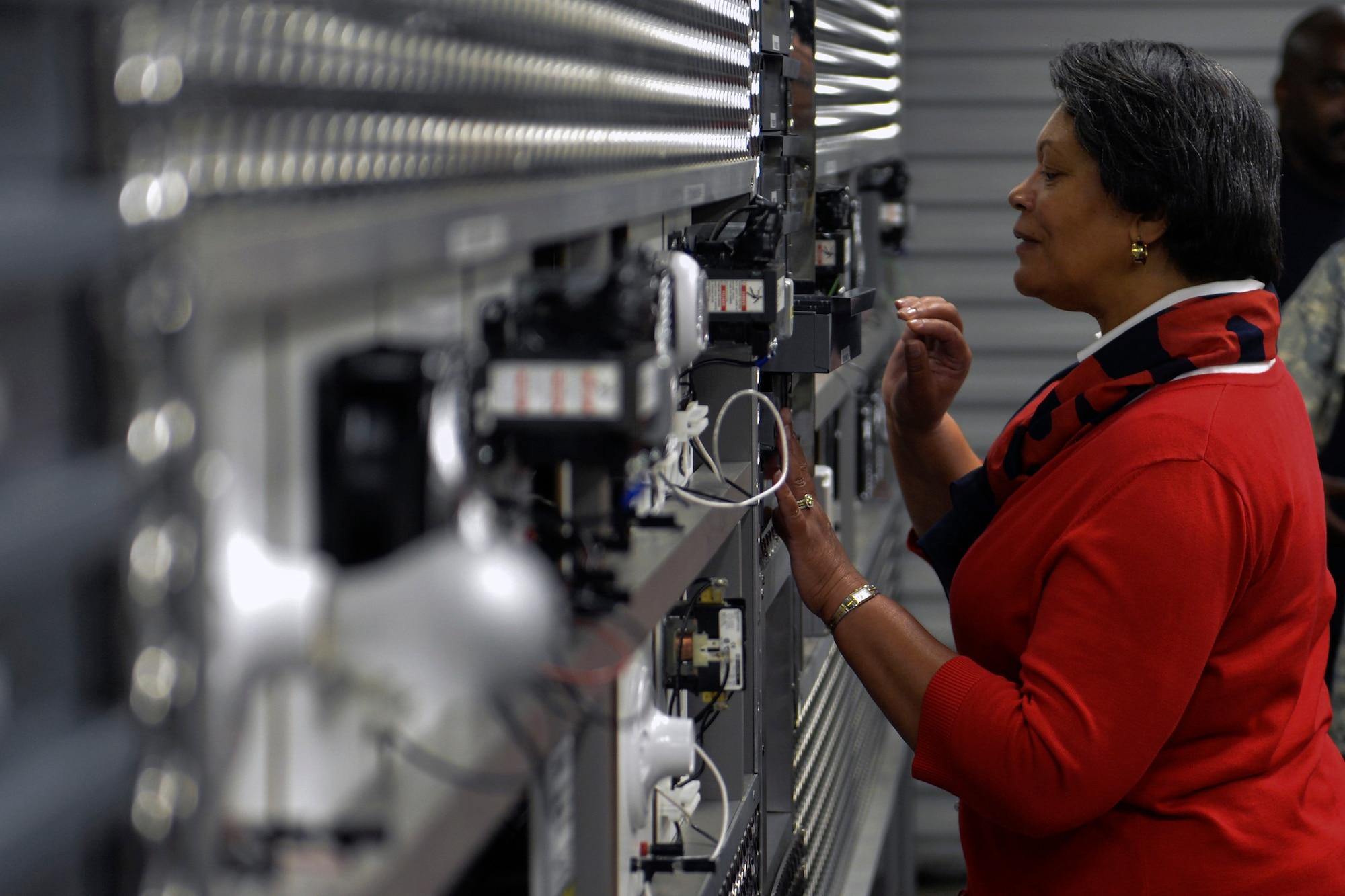 Mrs. Evelyn McDew, wife of Air Mobility Command commander Gen. Darren McDew, explores a heating, ventilation, air conditioning and refrigeration practice facility for Airmen and Soldiers utilizing transition service programs July 23, 2014, during an official base visit at Joint Base Lewis-McChord, Wash. Gen. and Mrs. McDew learned how transition service programs have exceeded expectations in creating numerous apprenticeship programs to provide post-service employment opportunities to service members. (U.S. Air Force photo/Staff Sgt. Russ Jackson)